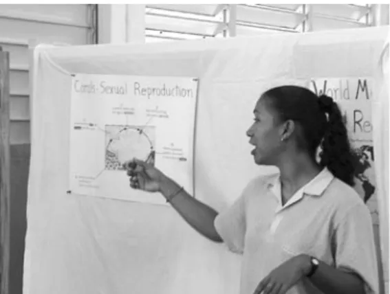Fig. 1. Buccoo Reef Trust Staff using a poster to illustrate  Coral Sexual Reproduction.