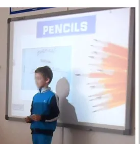 FIGURE 16: A student presenting his 