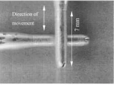 Fig. 3.Crossed-rod configuration used in this study. The lower contactterminal moves in the direction indicated by the arrows.