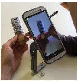 Figure 2: Setup A— participants sit at the table and hold the Easter egg in hand whilst the mobile device is fixed on a stand
