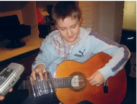 Fig. 12: The Secret Life of Objects. A guitar student, is exploring sounds with objects  from the collection