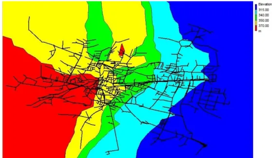 Fig. 1. Scheme of the WDN analyzed in the present work. The colormap represents terrain elevation