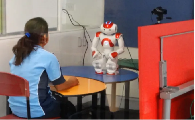 Figure 4.4: Setup: A Child playing snakes and ladders with NAO (back view)