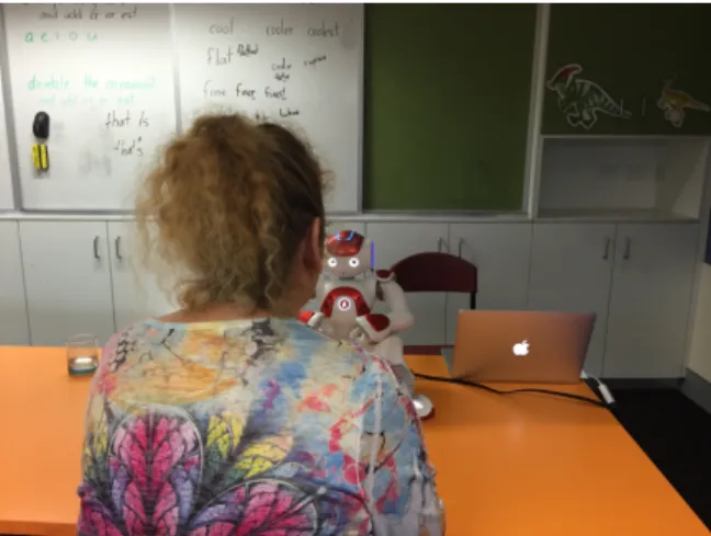 Figure 3.1: Setup: A teacher interacting with NAO.