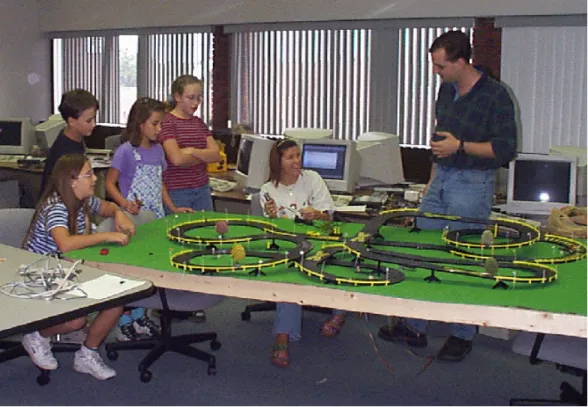 Figure 3 shows members of the student team (the two individuals on the right side of the image)  demonstrating their prototype to children visiting Kettering University
