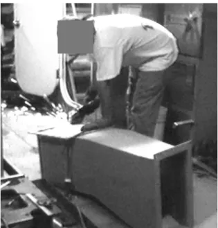 Figure 16.  Duct Worker Using Angle Grinder
