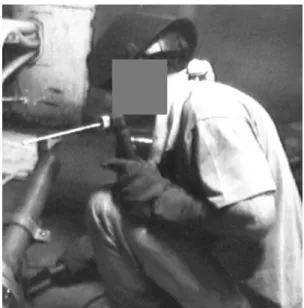 Figure 27.  Worker Using Hammer to Deslag Pipe Weld