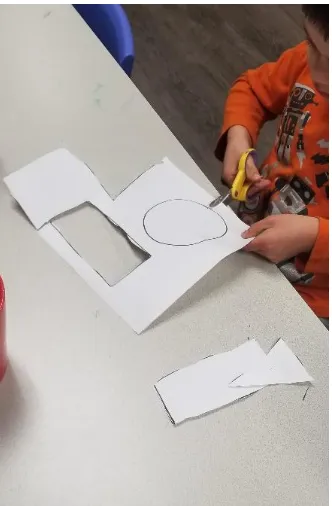 Figure 3. Cutting out paper shapes.  