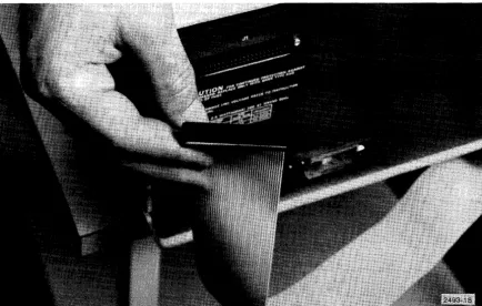 Figure 3-15. Plugging ribbon cable to connector J-1 on auxiliary cabinet. 