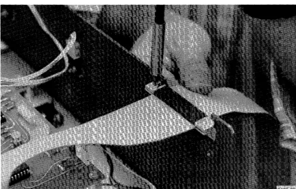 Figure 5-4. Securing ribbon cable at rear of main 4907 cabinet. 