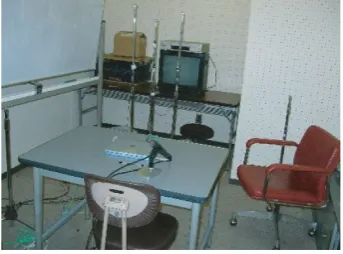 table and some chairs in the center of the room, one TV and
