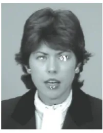 Figure 7: Image from visual telephone image sequence “Claire”with detected eye regions marked in black or white.