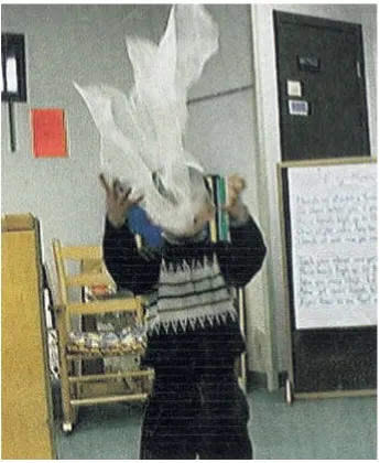 Fig. 1. The child is dancing with a scarf. The digital camera photograph captures the movementof the scarf.