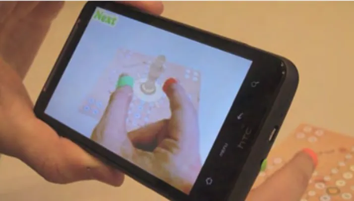 Figure 6: A green marker (thumb) and a red one (index fin- fin-ger) are used to track fingers and manipulate virtual objects on the board game