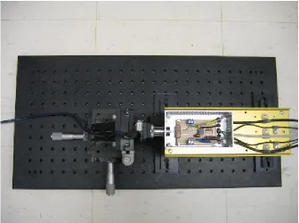 Figure 2.12 Side view of the voltage camera test setup showing the voltage camera test fixture, the webcam fitted with a 100X microscope lens and mounted on a XYZ translation device