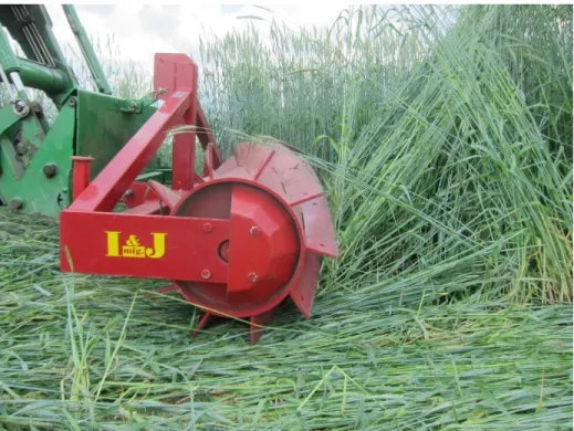 Fig. 1.1. A roller-crimper mounted on a front-end loader rolling a cereal rye cover crop