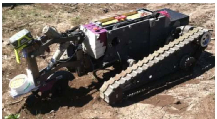 Figure 1: KSU- BAE UGV with a prototype planter sowing wheat seed.  