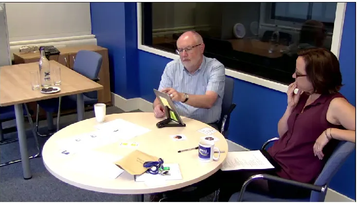 Figure 1. Example of testing set-up. Ian and Abi sit side-by-side as Ian interacts with an iPad app