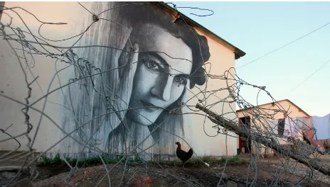 Fig.2: Slow’s portrait of ‘Ruth First’ painted onto the side of a matchbox house in Soweto