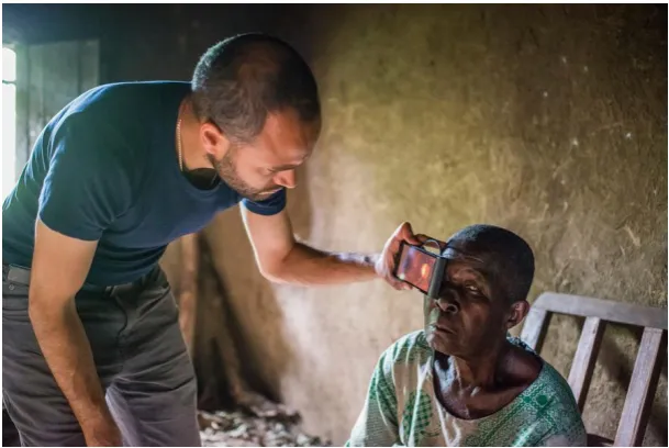 Figure 1. Smartphone based eye examination of a blind woman in Kenya. This work is being performed by the PEEK Vision Foundation [3,4]