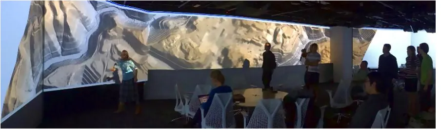 Figure 5. Students in the Multidimensional Geospatial Modeling course visualizing a digitalelevation model of an area affected by mountaintop mining in the Hunt Library Teaching andVisualization Lab.