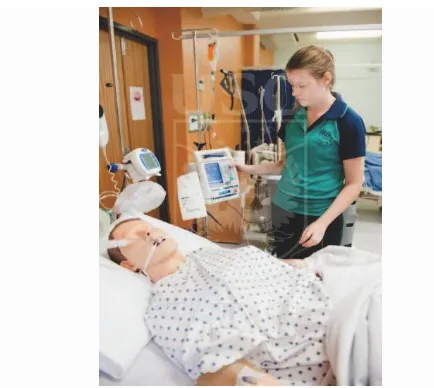 Figure 1. 1 st year nursing student tending to an IV infusion 