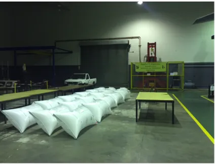 Figure 5.1: Image of the double-layered dunnage bags being preconditioned prior to testing, the hydraulic press can be seen in the background.