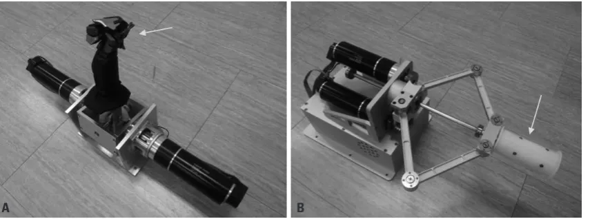 Fig. 1. The slave robot mounted on conventional colonoscope (arrow), and robotic arm (*) holding control body of colonoscope