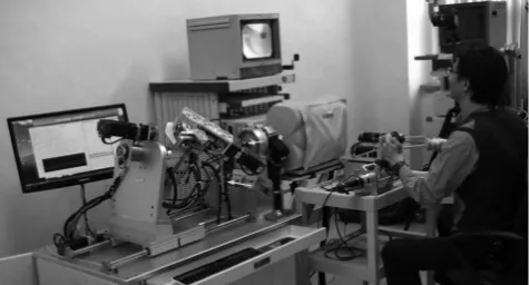 Fig. 3. Performing the colonoscopy using the whole master slave robotic system by a endoscopist (Dr