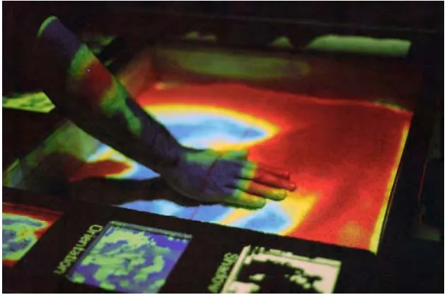 Fig. 4.4 The Sandscape [115] system as exhibited at the Ars Electronica Museum in Linz.The color projected onto the surface depicts the height proﬁle