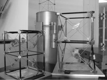 Figure 1.2: Deployable masts in the Space Structures Laboratory at Caltech, from left to right: twobays of the WSOA sample mast; Coilable boom in canister; two partially deployed bays of IPEX-II.