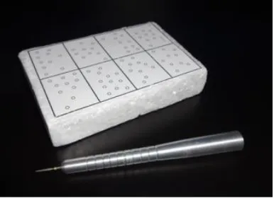 Fig. 1. Front and side view of the test cube and straight handpiece simulator with a #3195 diamond bur 