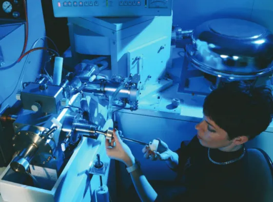 Figure 1  A scientist inserts a sample into a mass spectrometer. 