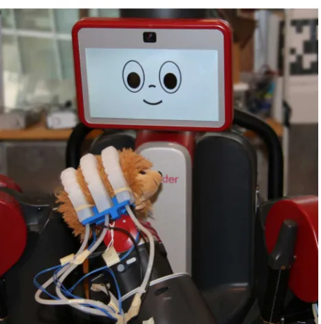 Fig. 1 The soft robotic hand, mounted to the wrist of a Baxter robot, ispicking up a sample object