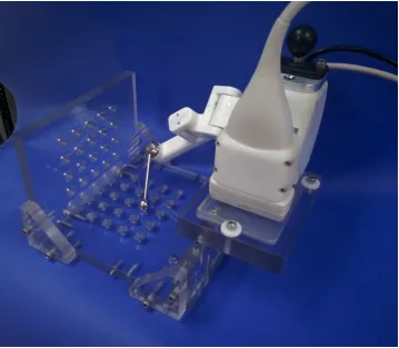 Figure 2.5: Guidance system positioned in tracking arm calibration jig. Jig contained45 fiducial divots arranged in a 9 × 5 grid pattern separated by 2 cm in each direction.Mounting position of scanner adjusted forward/back and left/right in 3 cm increments,so that 180 (45 × 4) known positions are available for calibration/validation.