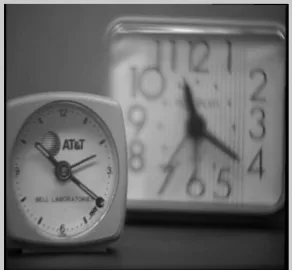 Fig. 3  Input image showing front clock in focus and rear clock is out of focus. 