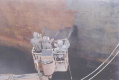 Figure 1. Manual removal of hull rust. 
