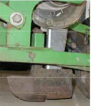 Figure 201 shows a gravity drop seed delivery system using a short dropper tube to convey the seed from a vacuum disc seed metering system to the furrow via the split cavity at the rear of a small runner type furrow opener