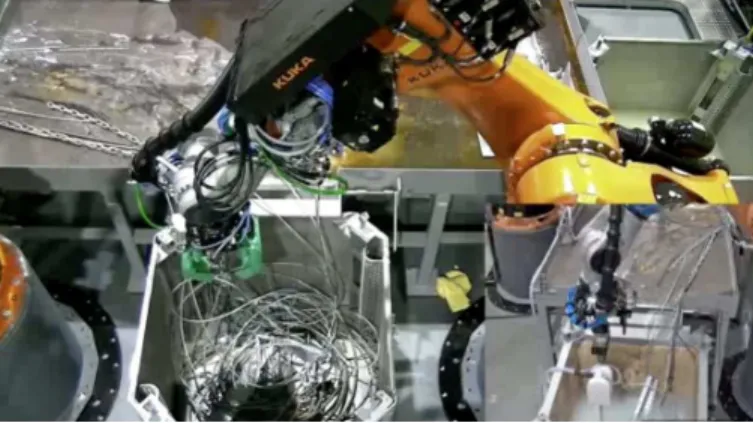 Fig. 1. In this figure, a robot is sorting nuclear waste (metal strings and chains) into a segregation bin through teleoperation.