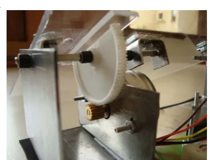 Figure 8: Details of the couch control mechanics.  A ‘half gear’ connected to the transparent plastic sheet (on the top) has a lower gear connected to the stepper motor