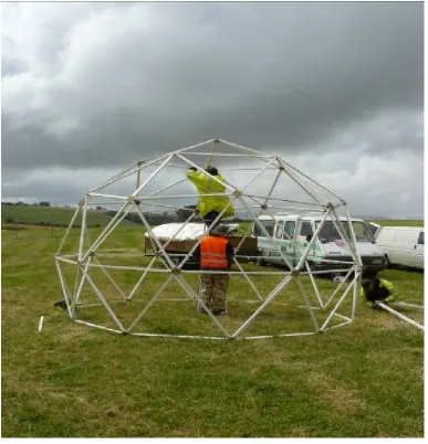 Figure 5: The day before show time, Geo-Lite’s Pete Wilson (orange, or darker, jacket) directed Flying Lotus’ Alan Turnbill as he connected hubs on the smaller of the psytrance stage two domes