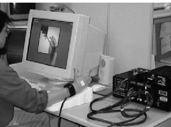 Figure 1. The PC based VR rehab system. The user is  wearing a CyberGlove that is connected to the interface  unit on the right
