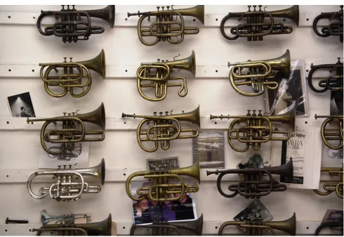 Fig. 1 A portion of the author’s “Wall of Cornets” showing some of the different models being made in the early history of cornet design andmanufacture