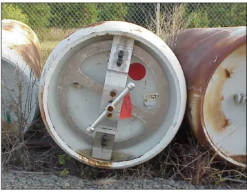 Figure 2-2. Ton Container With Fixture Securing End  Plugs 
