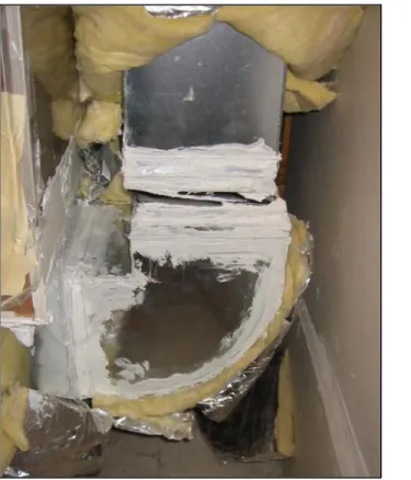 Figure 27. Duct sealers here were faced with a tight space and existing insulation. The insulation was cut and  temporarily pulled back to seal connections within reach