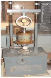 Fig 4. California bearing ratio testing machine and the specimen undergoing testing. 