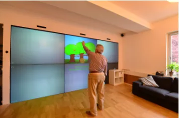 Figure 5. An elderly player interacting with a prototype of the fruit picking game.