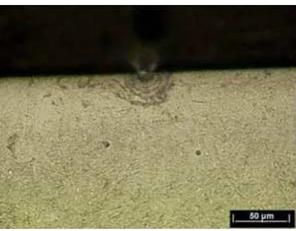 Figure 10. Subsurface micrograph of MMV 2 layer wear sample showing pore at disc surface with associated cracking after 30,000 dry cycles