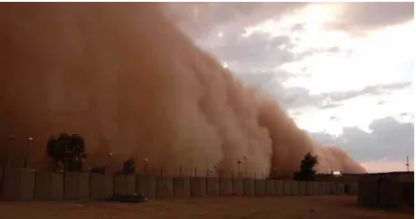 Figure 2. Dust storm in the Iraqi Western Desert, west of Fal- luja. Compare the height of the front with the heights of the buildings, and note the clouds, which accompanied the dust storm