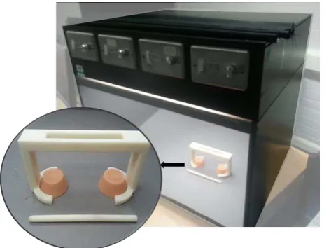 Figure 4: D65 daylight simulator with the stimuli placed in the holder and the tool used, as presented to each participant 